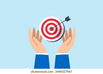 Businessman hand holds bullseye with arrow, illustrating aiming business target accurately. Concept of setting goals, focus and concentration to achieve success, pursuing objectives with purpose