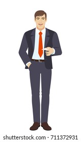 Businessman with hand in pocket gives a business card. Full length portrait of businessman character in a flat style. Vector illustration.
