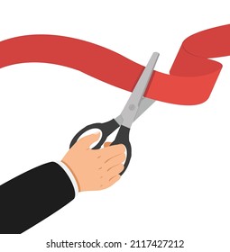 Businessman hand  with scissors cut red ribbon Grand opening concept