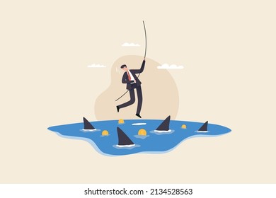 businessman hangs on for dear life from a rope as he swings above a group of circling sharks in the sea. Risk taker, challenge to success, overcome difficulty or problem in crisis or entrepreneurship.