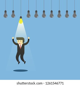 Businessman happy jumping under the shining lamp. Symbol of get an idea that glowing the path.