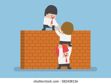 Businessman help his friend to cross the brick wall, teamwork concept