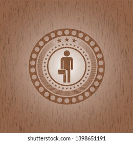 businessman holding briefcase icon inside badge with wooden background