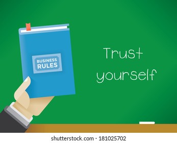 Businessman Holding Business Rules Book In Front Of The Blackboard With Text Trust Yourself