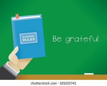 Businessman Holding Business Rules Book In Front Of The Blackboard With Text Be Grateful