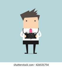 Businessman holding a camera vector