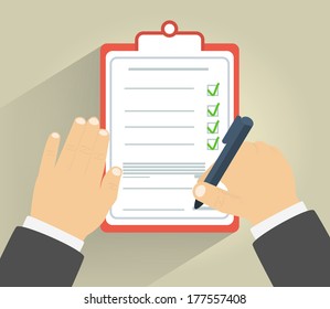 Businessman holding a clipboard and writing signature