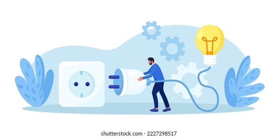 Businessman holding electrical plug with cord, connecting light bulb to power outlet. Business idea, solution. Investment in new project development, startup. Search for ideas and brainstorming
