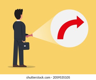 Businessman holding flashlight uncovering hidden arrow sign. The idea of discovering hidden success