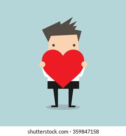 Businessman holding heart shape vector