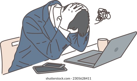 Businessman holding his head in front of a computer
