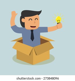 businessman holding a ligh tbulb in a box