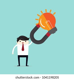 Businessman holding magnet with a light bulb. The concept of stolen ideas