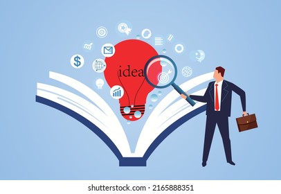 Businessman holding magnifying glass looking for business inspiration and ideas in books, education and learning, business training