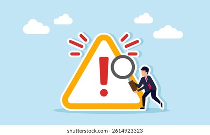 Businessman holding a magnifying glass next to an exclamation mark with a splash effect, illustration of the need for special attention to risky matters