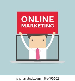 Businessman holding Online Marketing sign in computer notebook
