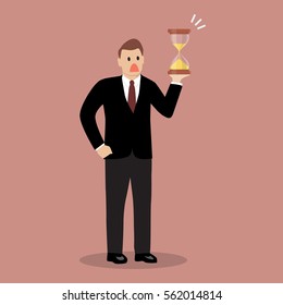 Businessman holding sandglass. Business deadline concept