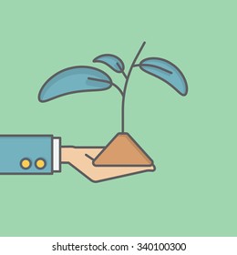 businessman holding seedling
