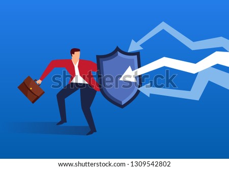 Businessman holding shield against falling arrow