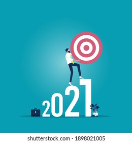Businessman holding target and walking up on 2021 number to the target, success, Career, Business concept growth to success in 2021