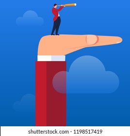 Businessman holding a telescope standing on the palm of a giant