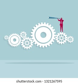 Businessman holding a telescope. Standing on the gears. The background is blue.