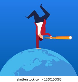 Businessman holding a telescope standing upside down on earth