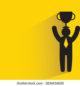 businessman holding trophy with drop shadow on yellow background