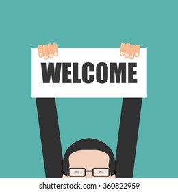 Businessman holding welcome banner