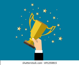 Businessman holding up a winning trophy. Business concept