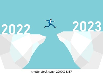 businessman jump cross the gap from year 2022 to 2023. Happy new year 2023 hope for business success, opportunity, career, and enjoy life.