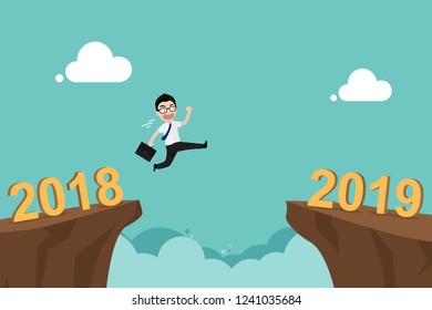 Businessman jump over cliff gap from 2018 to new year 2019. Concept for success and future goal in business. New year change