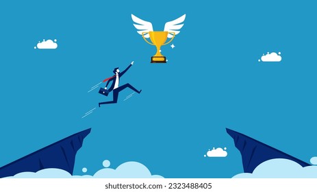 Empresario saltando para coger un trofeo