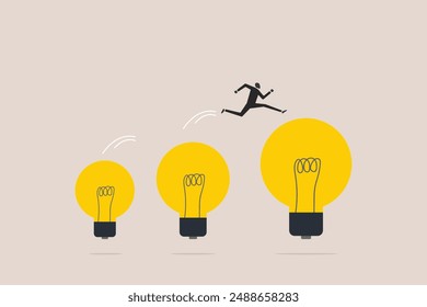 Businessman jumping on bigger lightbulb, successfully. concept of goal, achievement, advancement in career or business growth concept. Aspiration and motivation