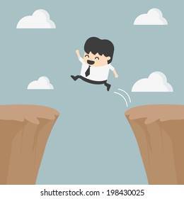 Businessman jumping over the cliff
