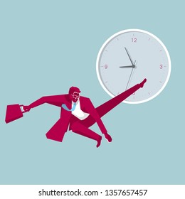 Businessman jumps in front of the clock. Isolated on blue background.