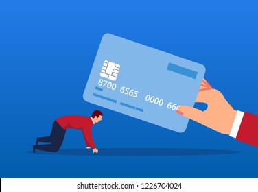 Businessman kneels in front of a credit card