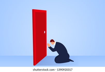 Businessman kneels in front of the door and prays to open the door