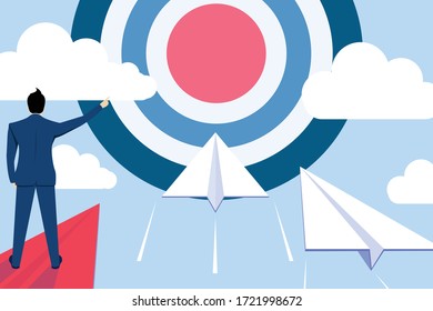 Businessman leader point finger to dartboard, Standing on red paper plane to command or supervising white paper plane  flying at the target, To goal to achieve success, business Concept.