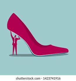 Businessman lifting high heels. Isolated on blue background.