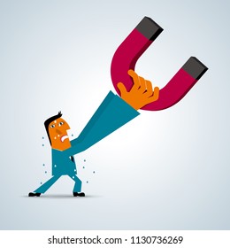 Businessman lifts the magnet,Businessman wearing a blue suit,The magnet is red and black.