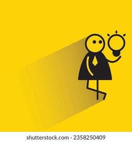 businessman and light bulb with shadow on yellow background