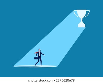 Businessman looking at the light from the trophy