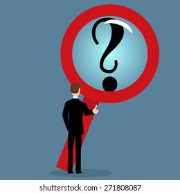 Businessman looking at a question mark through a magnifying glass