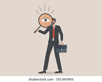 Businessman looking through a magnifying glass