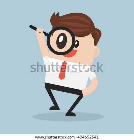 Businessman looking through a magnifying glass