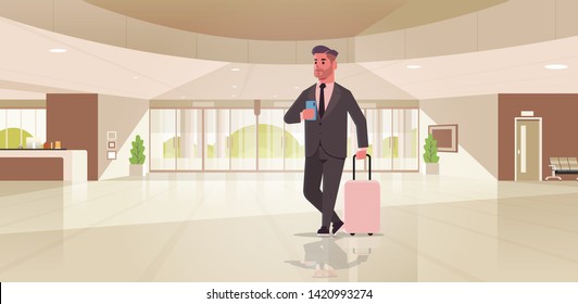 businessman with luggage modern reception area business man holding suitcase guy standing in lobby contemporary hotel hall interior flat horizontal full length