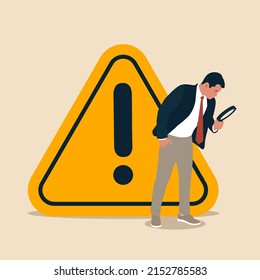Businessman with magnifying monitor and investigate incident with exclamation attention sign. Incident management, root cause analysis or solving problem, identify risk or critical failure concept.
