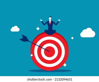 Businessman meditate sitting and focusing on big archer target. Stay focused and concentrate on business objective