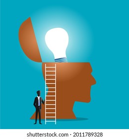 businessman next to stairs and light bulb coming out of transparent head